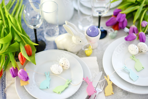 Beautiful table setting with crockery and flowers for Easter celebration