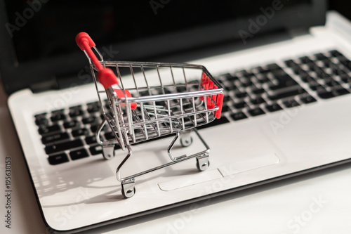 Small red shopping cart on laptop, Technology business online shopping concept