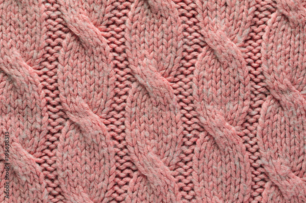 Knit Texture of Pink Wool Knitted Fabric with Regular Cable Knitted Pattern. Blank Background