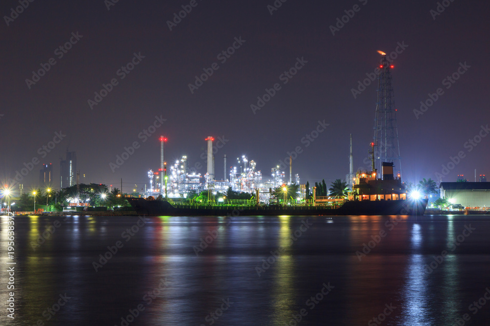 Oil refinery at the river in sunrise time / Big Factory in night time