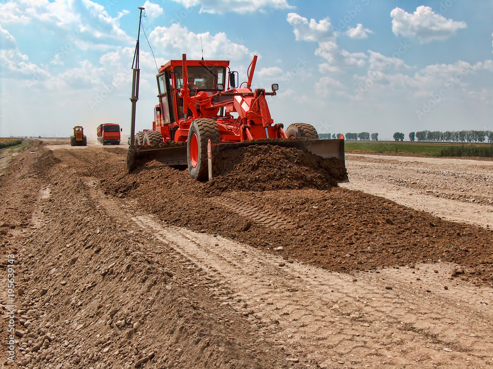 Obraz premium Grader adjust elevation level soil for construction site