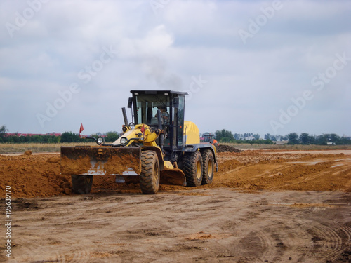 Grader adjust elevation level soil for construction site
