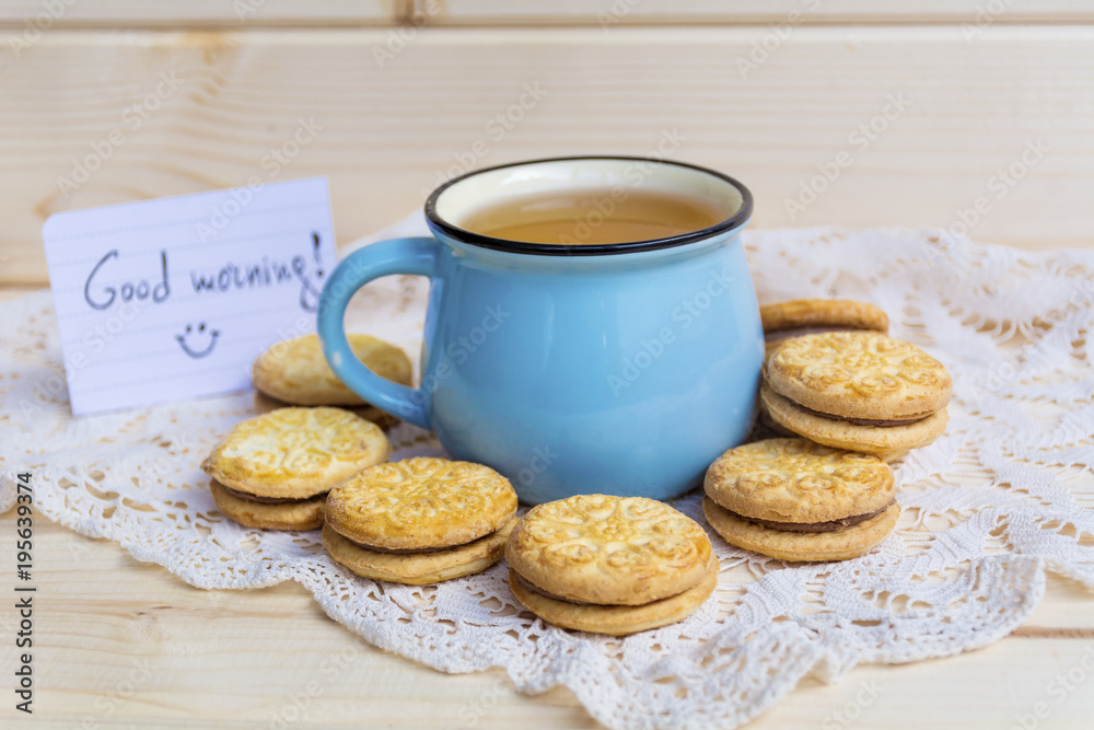 blue mug of tea and oatmeal cookies on wooden background blue mug of tea and oatmeal cookies on wooden background