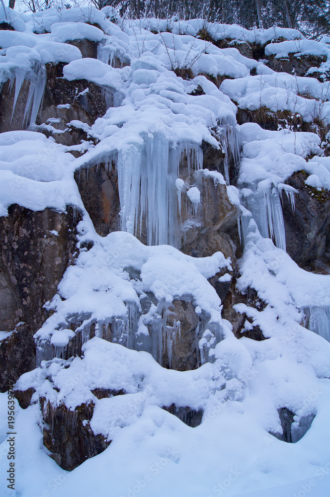 Frozen waterfall with rock