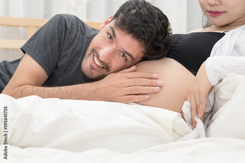 In Selective Focus Of Happy Family Checking New Baby In The Morning.Close Up Of A Beautiful Happy Pregnant Woman With Big Belly. Pregnancy And Motherhood Moment People And Expectation Concept. In Selective Focus Of Happy Family Checking New Baby In The Morning.Close Up Of A Beautiful Happy Pregnant Woman With Big Belly. Pregnancy And Motherhood Moment People And Expectation Concept.