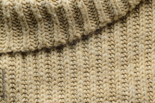 Beige Sweater Texture Close-Up. Elements of Knitted Sweater as Background