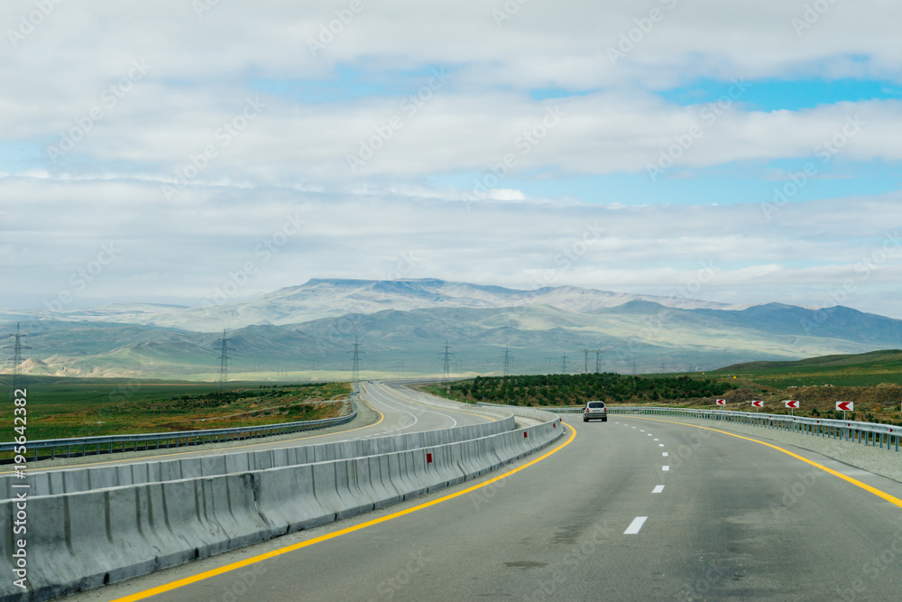 road, a highway at the foot of the mountains