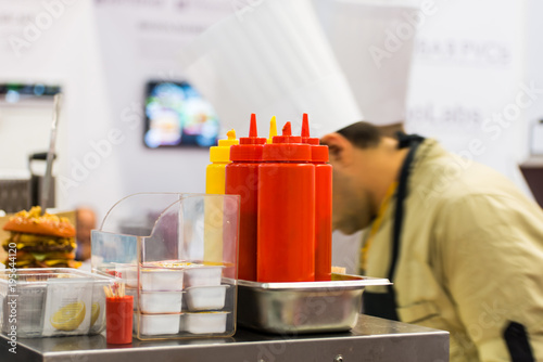 ketchup and mustard on the counter of restaurant photo