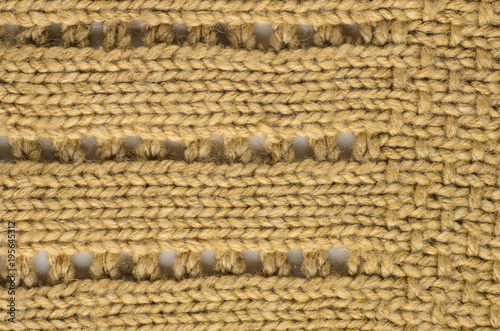 Beige Texture of a Knitted Sweater with Two Types of Knitting. Knit texture as background.