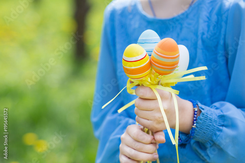 Child holding Easter eggs in hands close-up