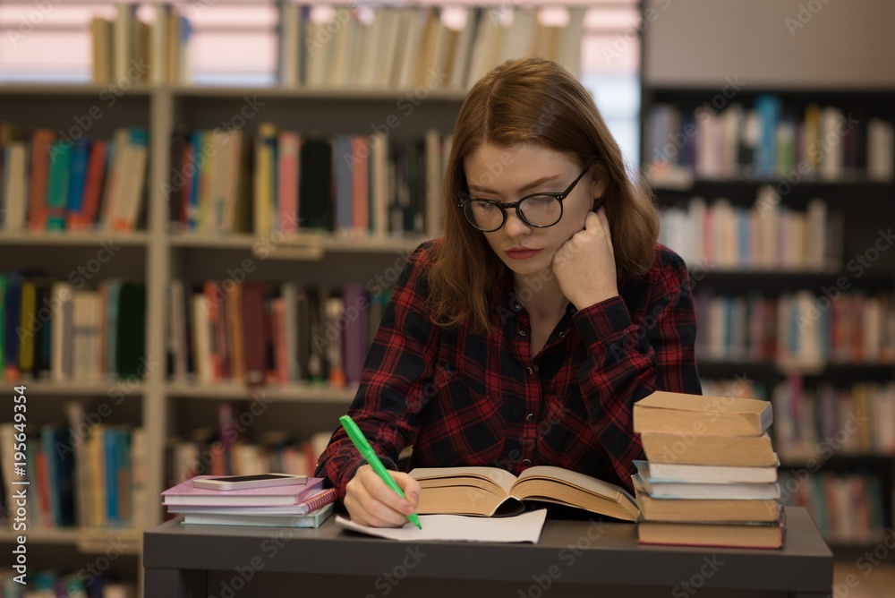 Young woman writing on paper Young woman writing on paper