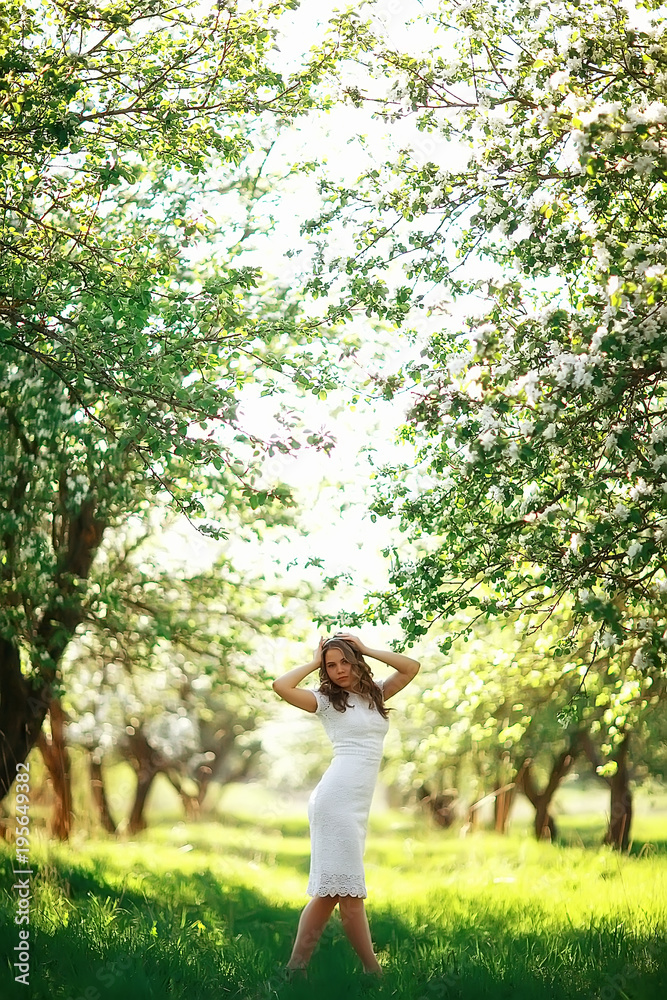 girl spring / portrait of a beautiful girl in a spring blooming park, apple blossoms, beauty, cleanliness, freshness, the smell of spring