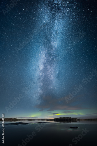 Aurora Borealis aka Northern Light above partly iced lake