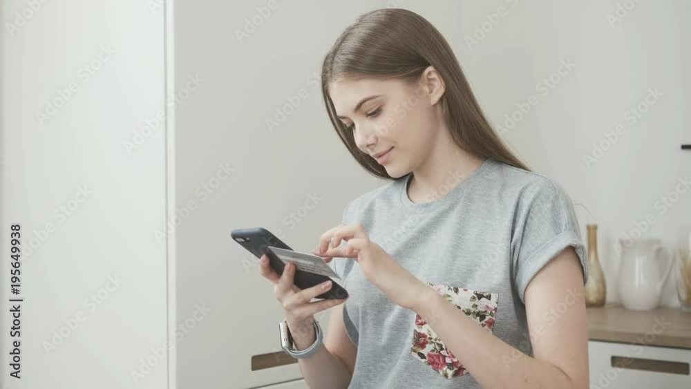 Online banking with smart phone. Lifestyle. Easy pay using smart phone or digital device. Communication via app for sale in shop. Beautiful girl looking at camera and smiling. Online banking with smart phone. Lifestyle. Easy pay using smart phone or digital device. Communication via app for sale in shop. Beautiful girl looking at camera and smiling.