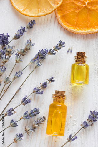 essential oil of orange, lemon and lavender for aromatherapy against stress on a white wooden background top view