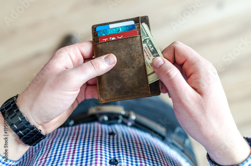 Man holding leather wallet
