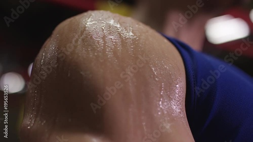 Close up of a bodybuilder's sweaty shoulder  photo