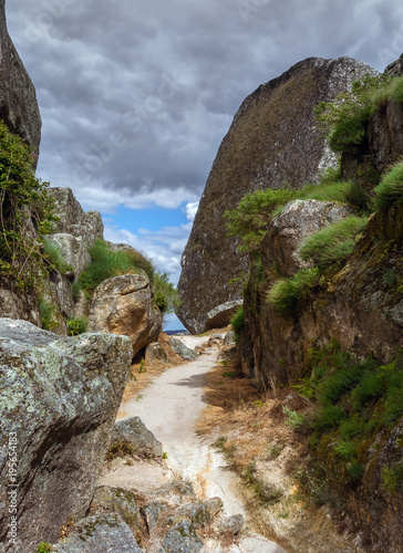 Narrow path between stones the way to the Monsanto castle photo