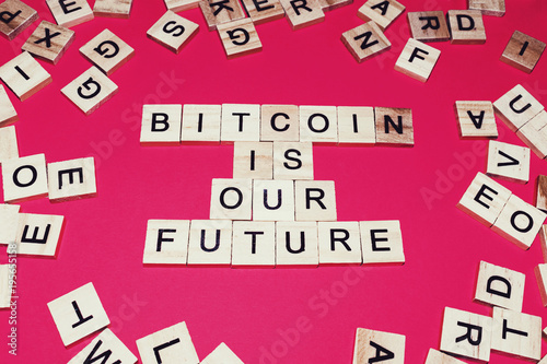 Wooden blocks on a red background spelling words Bitcoin is our Future