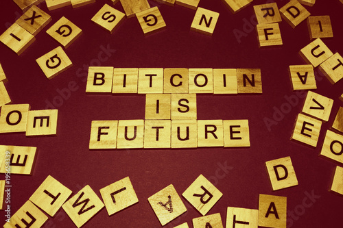 Wooden blocks on a brown background spelling words Bitcoin Is Future