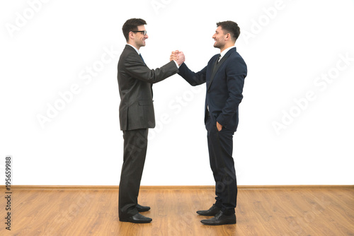 The two businessmen greeting on the white wall background