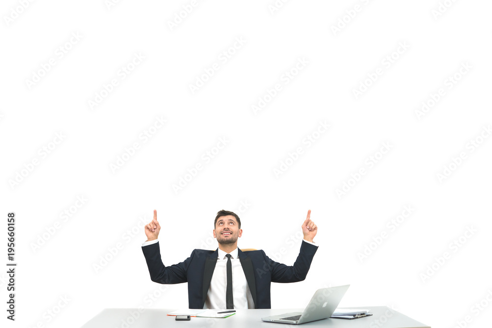 The businessman sitting at the desktop and gesturing on the white background The businessman sitting at the desktop and gesturing on the white background