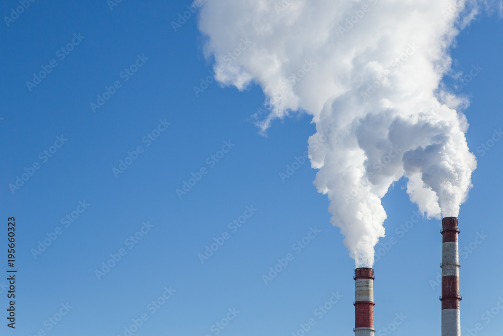 Air pollution. Factory pipes with smoke in the blue sky. Ecology problem Air pollution. Factory pipes with smoke in the blue sky. Ecology problem