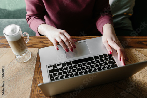 Female working on laptop in a cafe. woman using laptop in home. using laptop internet. hand using laptop in coffe shop