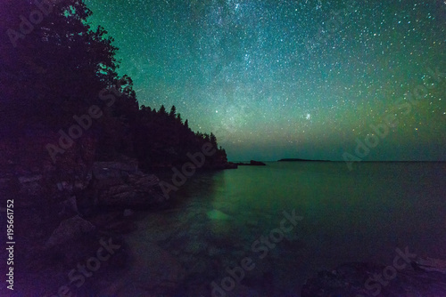 Milky way and starry sky along the lakeshore of Georgian Bay at night © claire