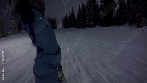 Snowboard Slash POV at Night in Mountain Resort photo