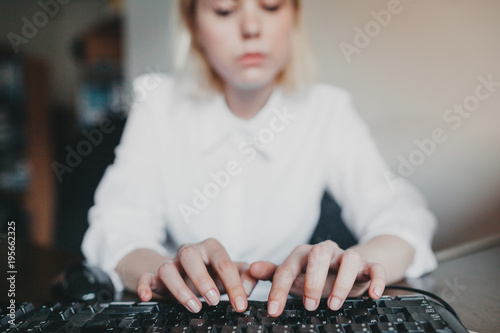 Detail of hands working on keyboard