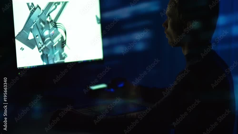 The engineer working with a 3d modeling in a computer. evening night time