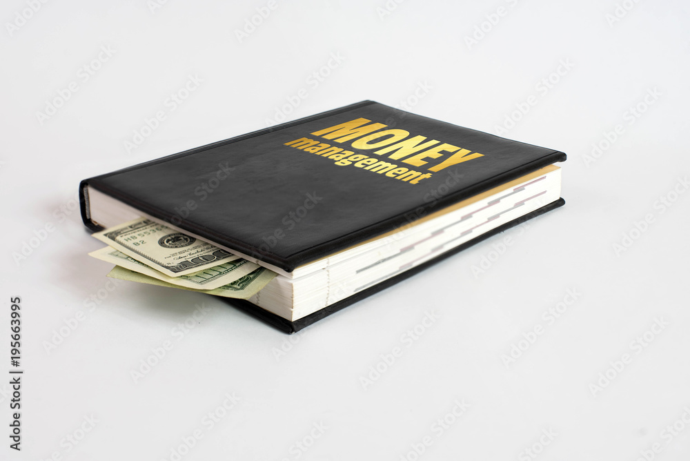 Black book with money and the inscription money management on white background Black book with money and the inscription money management on white background