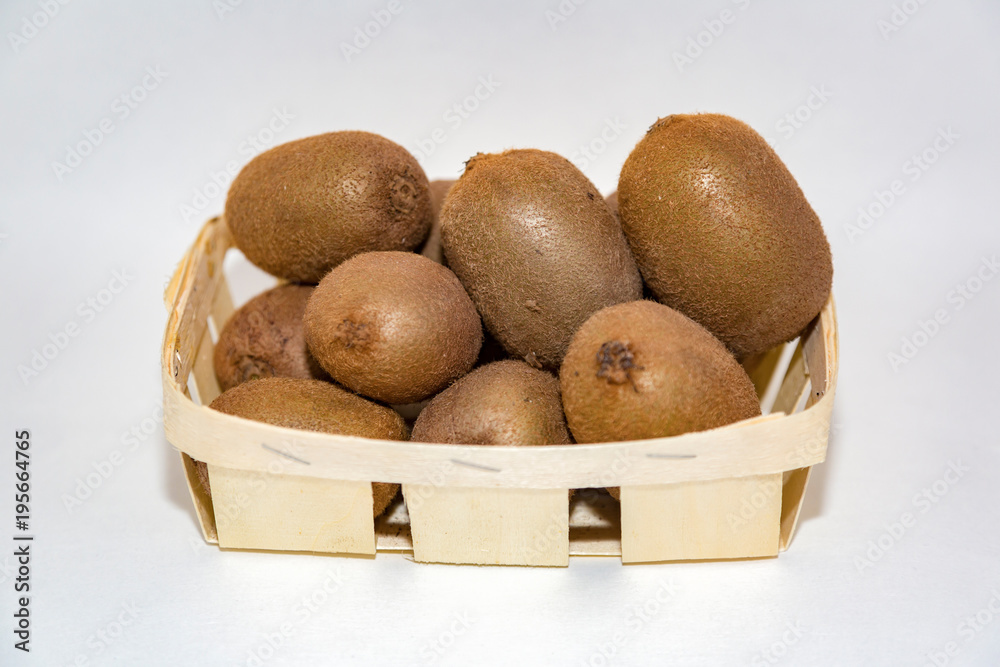 Few appetizing shaggy kiwis lie in a birch bark pottle
