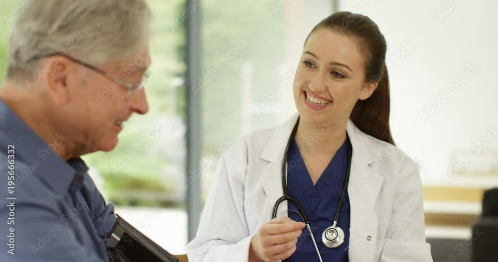 4K Friendly female doctor giving medical check to cheerful senior man 4K Friendly female doctor giving medical check to cheerful senior man