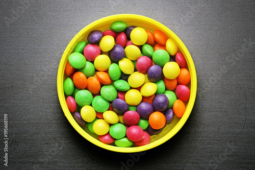 Colorful sweet candies on a grey background
