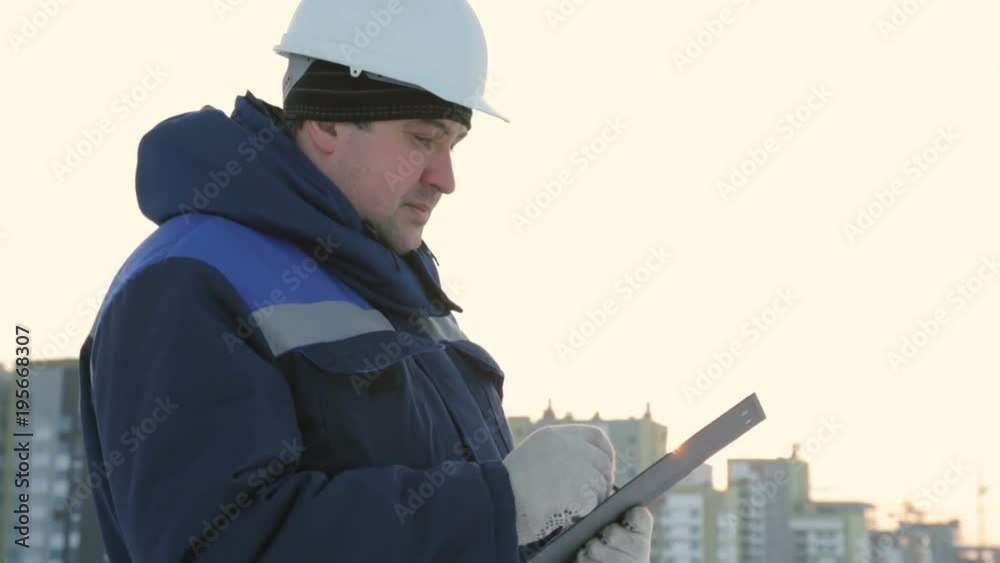 Foreman with tablet at major construction project