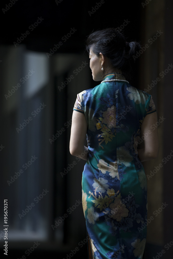 Back view of senior asian woman in cheongsam