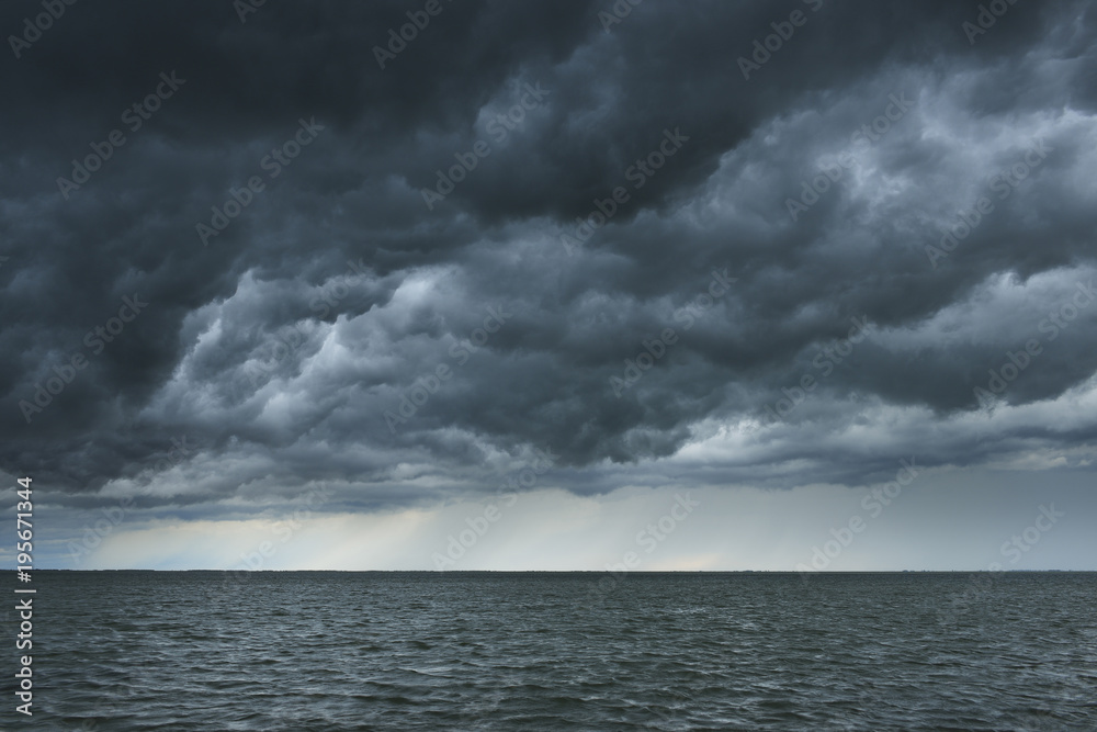 Storm clouds over lake, Etang de Vaccares, France Storm clouds over lake, Etang de Vaccares, France