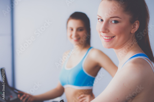 Group of people at the gym exercising on cross trainers. people at the gym photo