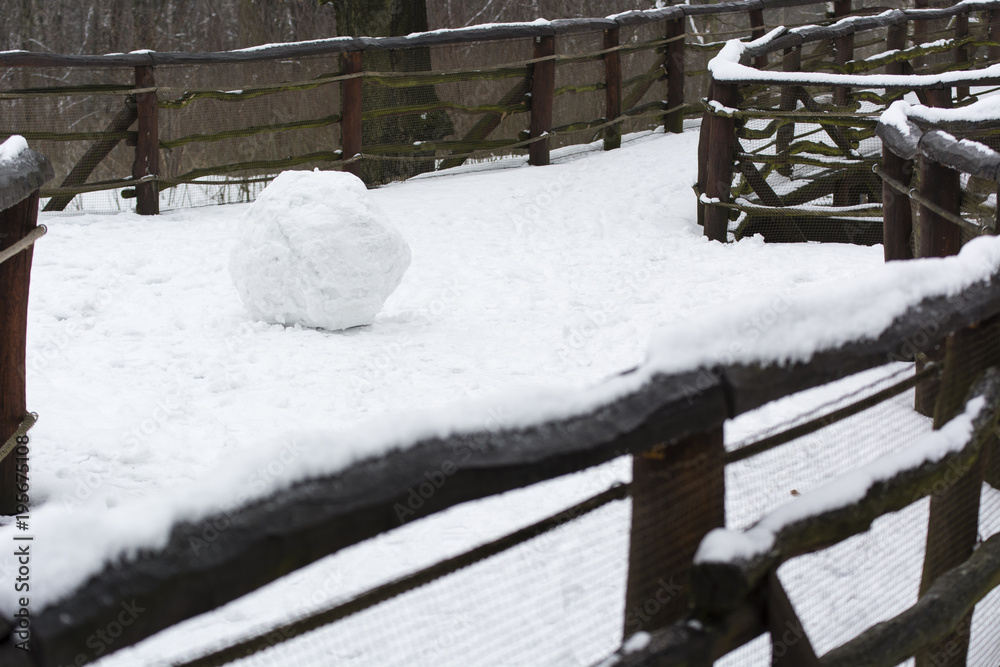 A big snowball on a wooden path. A big snowball on a wooden path.