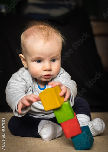Baby boy playing with wooden blocks