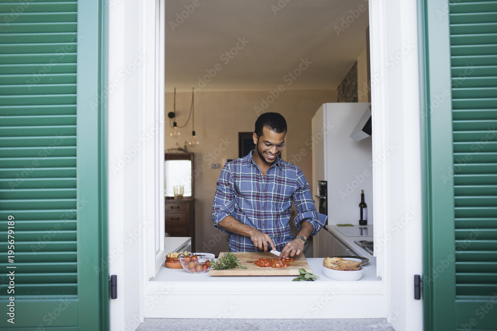 Smiling man preparing a vegetarian dish Smiling man preparing a vegetarian dish