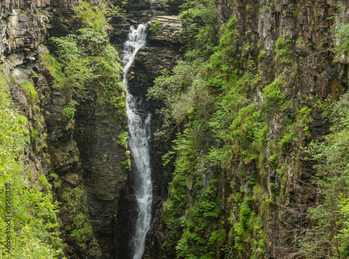 Braemore, Scotland - June 8, 2012: Closeup of waterfall of Corrieshalloch Gorge, a deep cut in landscape with forested vertical slopes. Landscape photo.