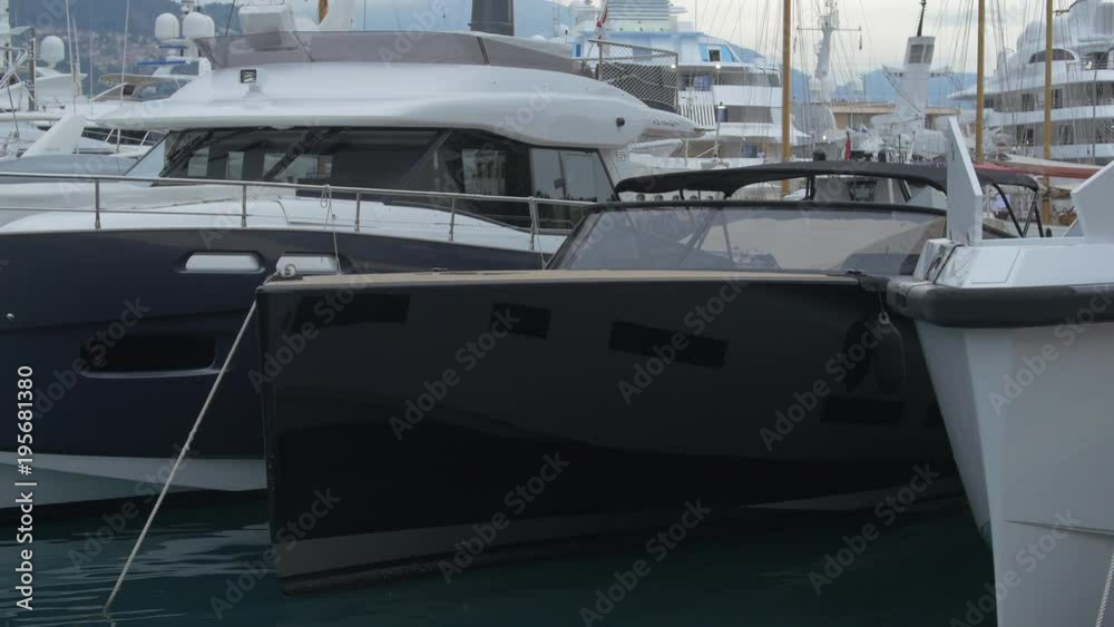 Black and white boats anchored in a port Black and white boats anchored in a port