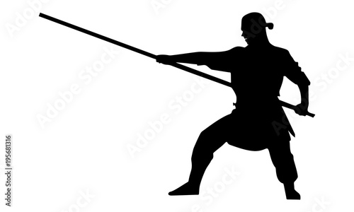 silhouette of a male ninja with a stick