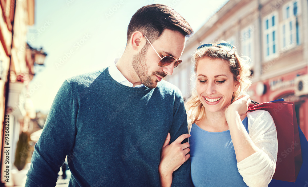 Fototapeta premium Shopping time. Young couple in shopping. Consumerism, love, dating, lifestyle concept