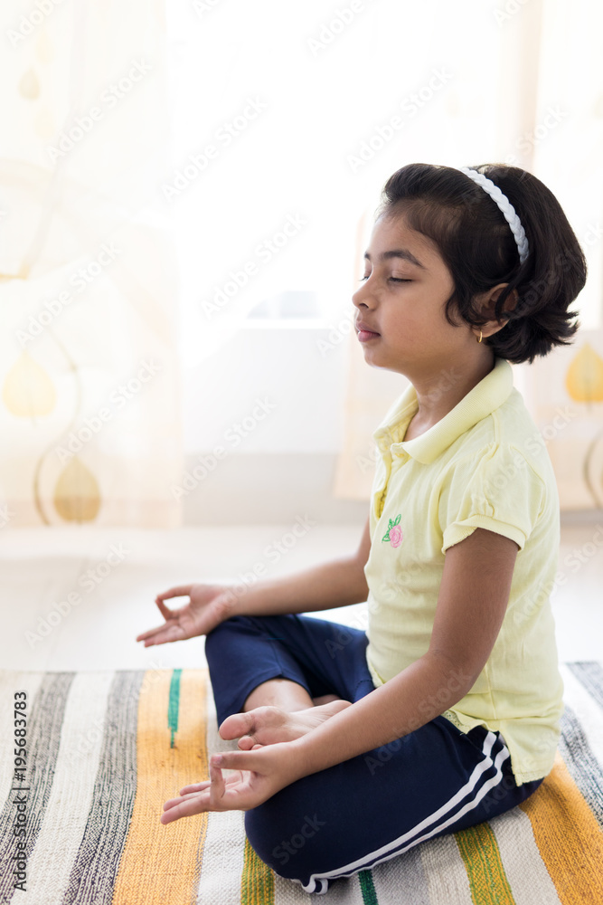 Little girl practicing yoga indoors Little girl practicing yoga indoors