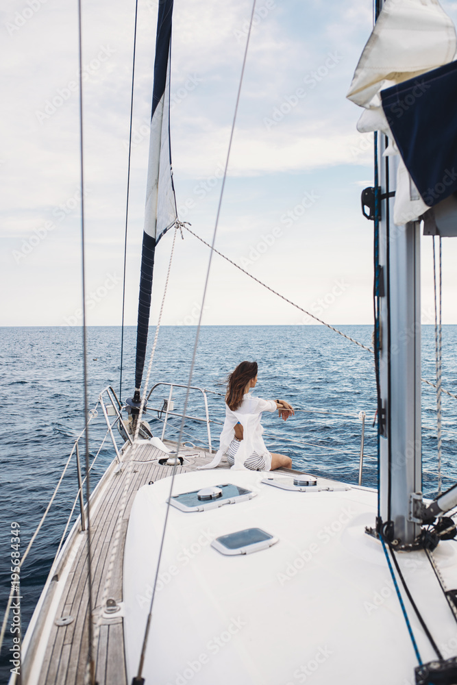 Woman Enjoying Sea on Sailboat Woman Enjoying Sea on Sailboat