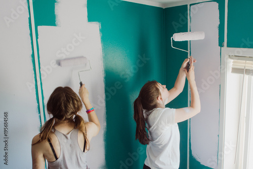 teenagers painting walls in a room photo